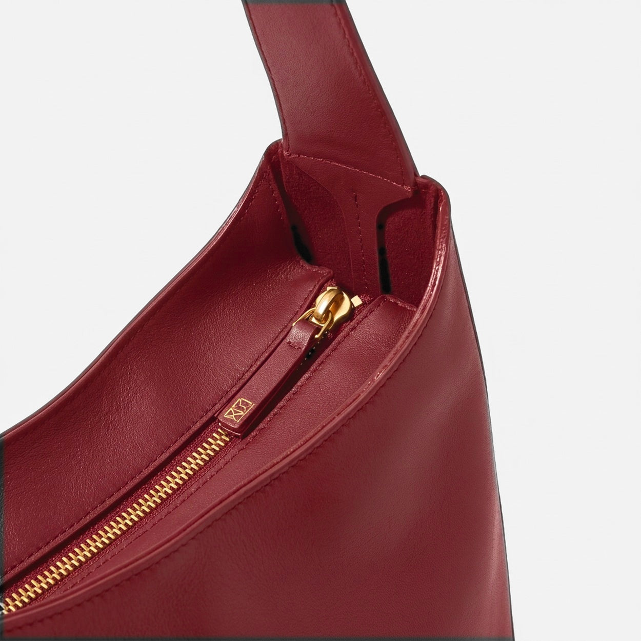 The Overtime Lite top zip detail in full-grain leather -Cherry Cola