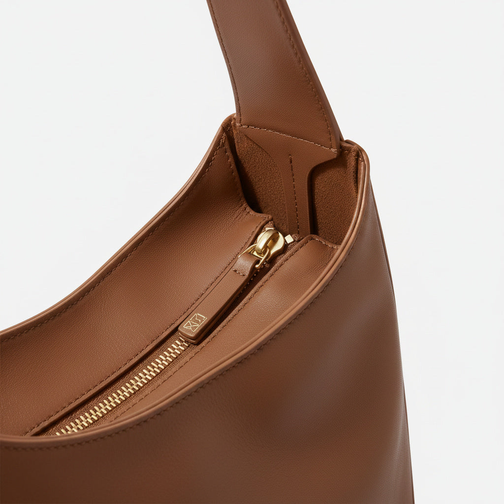 The Overtime Lite top zip detail in full-grain leather -Saddle