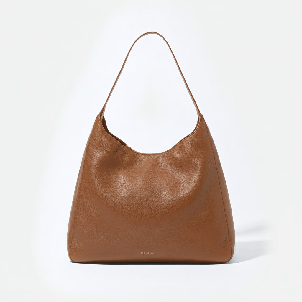 Brown leather handbag on a white background - Saddle