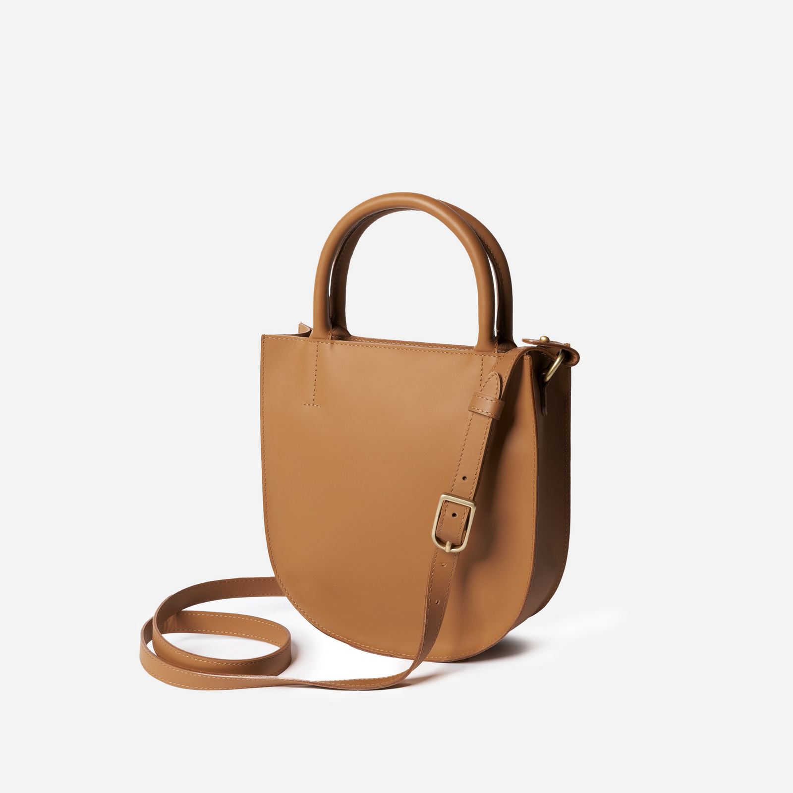 A black leather crossbody bag with an adjustable strap and solid brass hardware, viewed from the front. - Black
