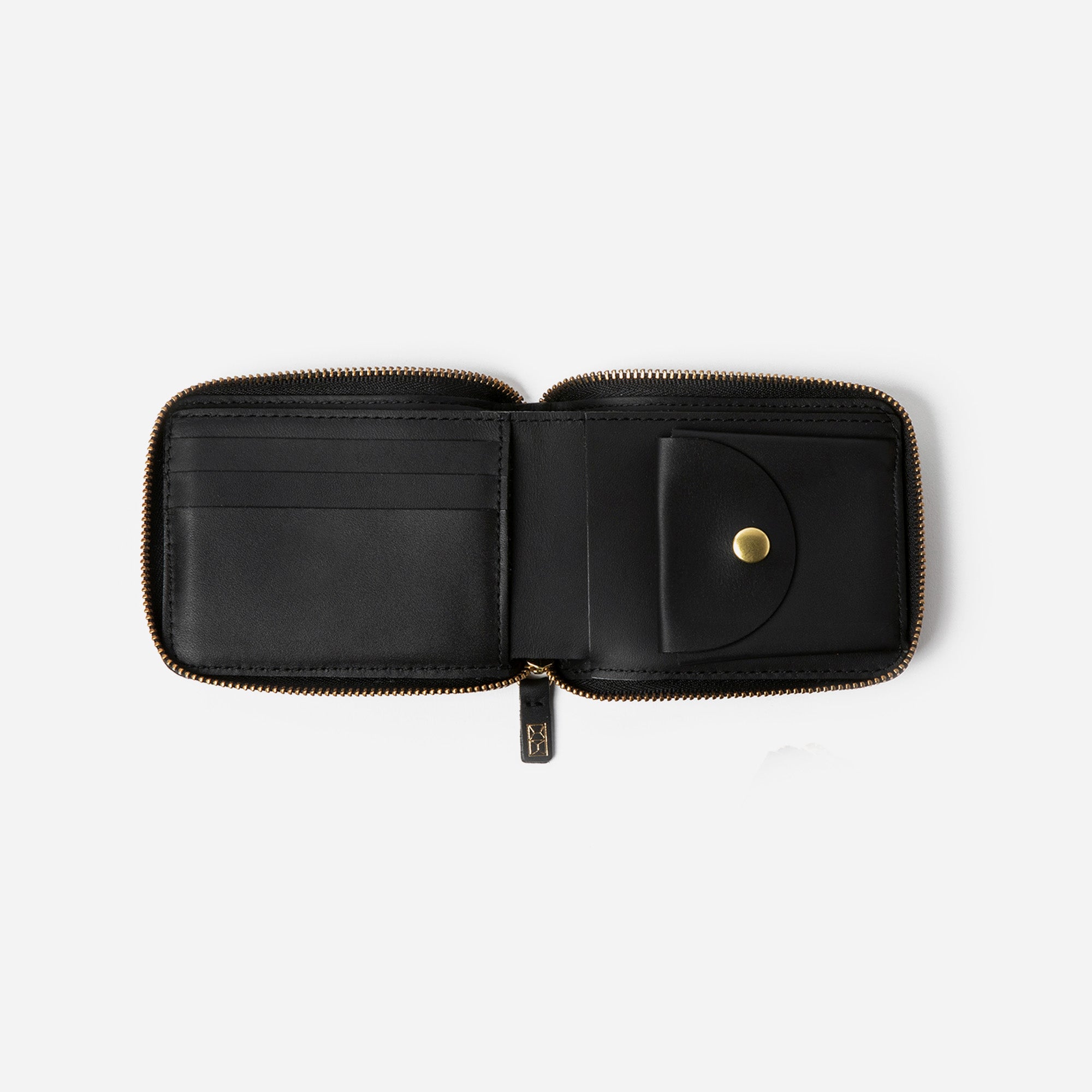 Brown wallet with 'Minor History' branding on a pink fabric background - Saddle