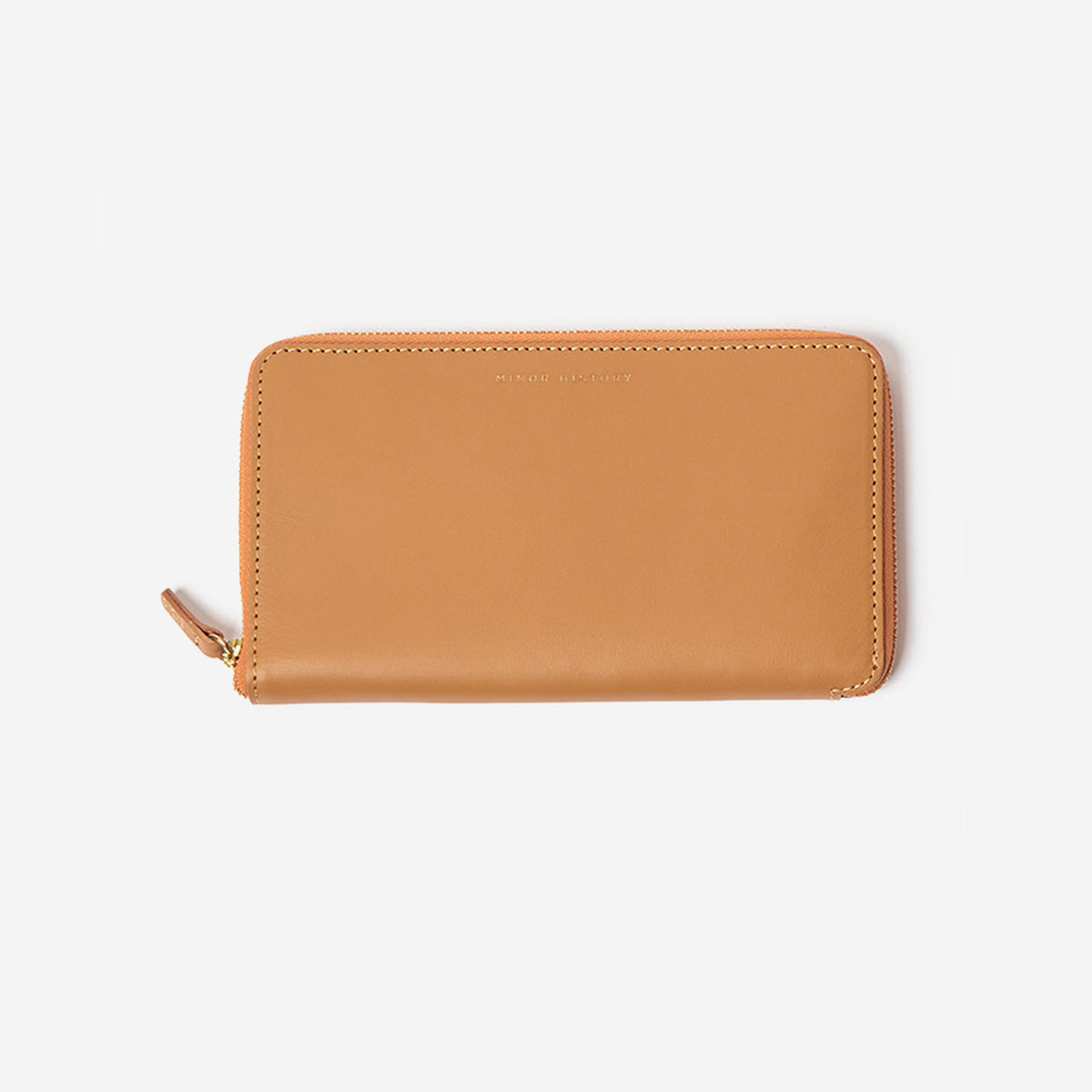 Tan wallet with a gold zipper on a white background - Saddle