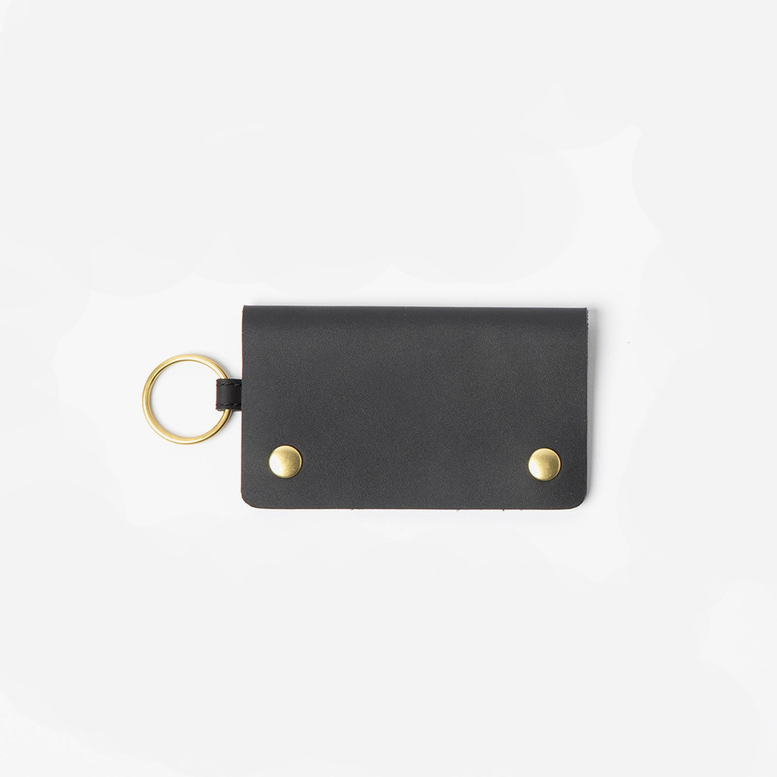 Black keychain cardholder with gold accents on a white background - Black