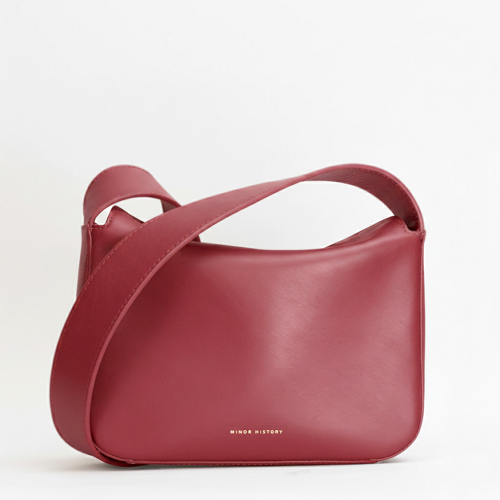 Red handbag with a strap on a white background - Cherry Cola