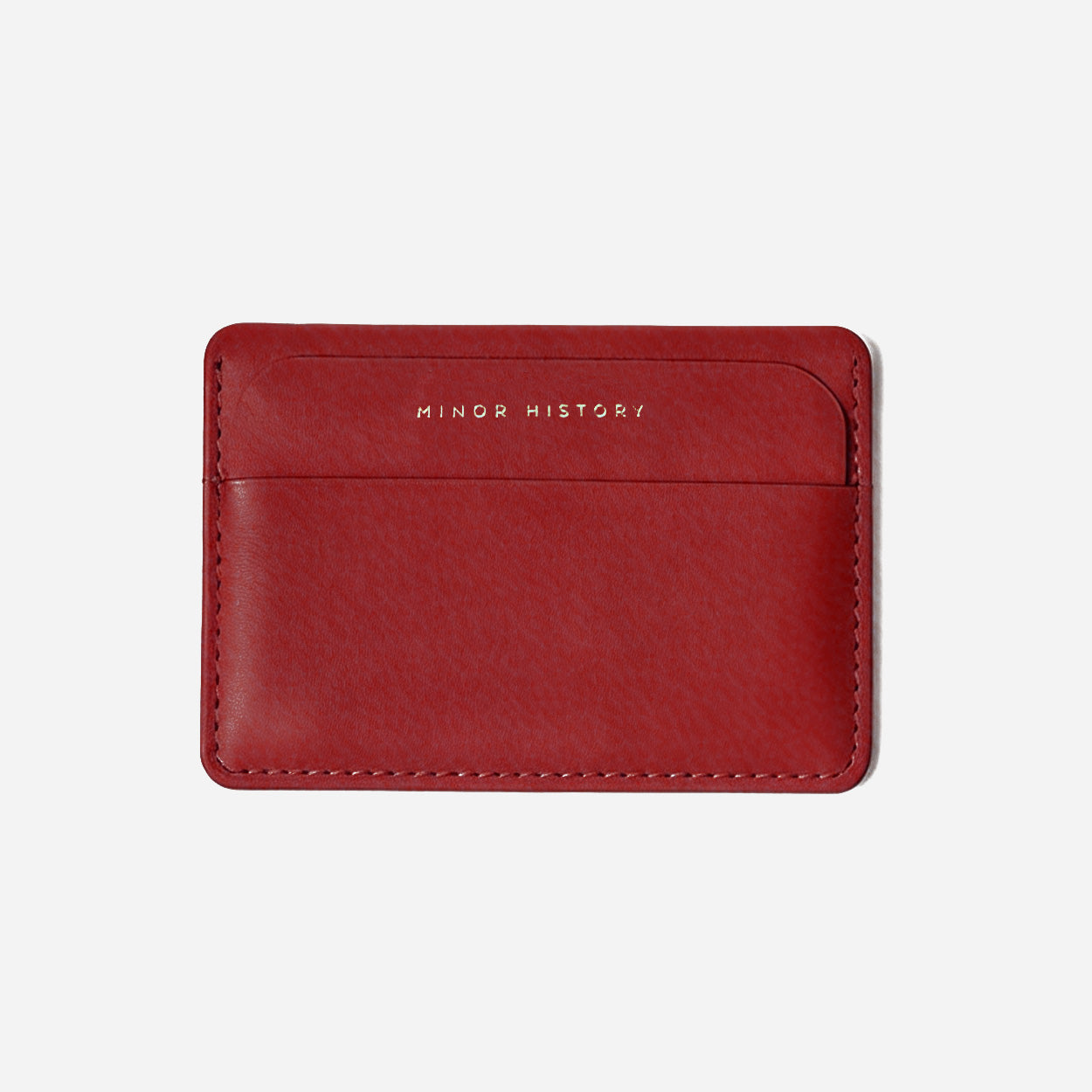 Gold cardholder with 'Ninety History' branding on a white background - Golden