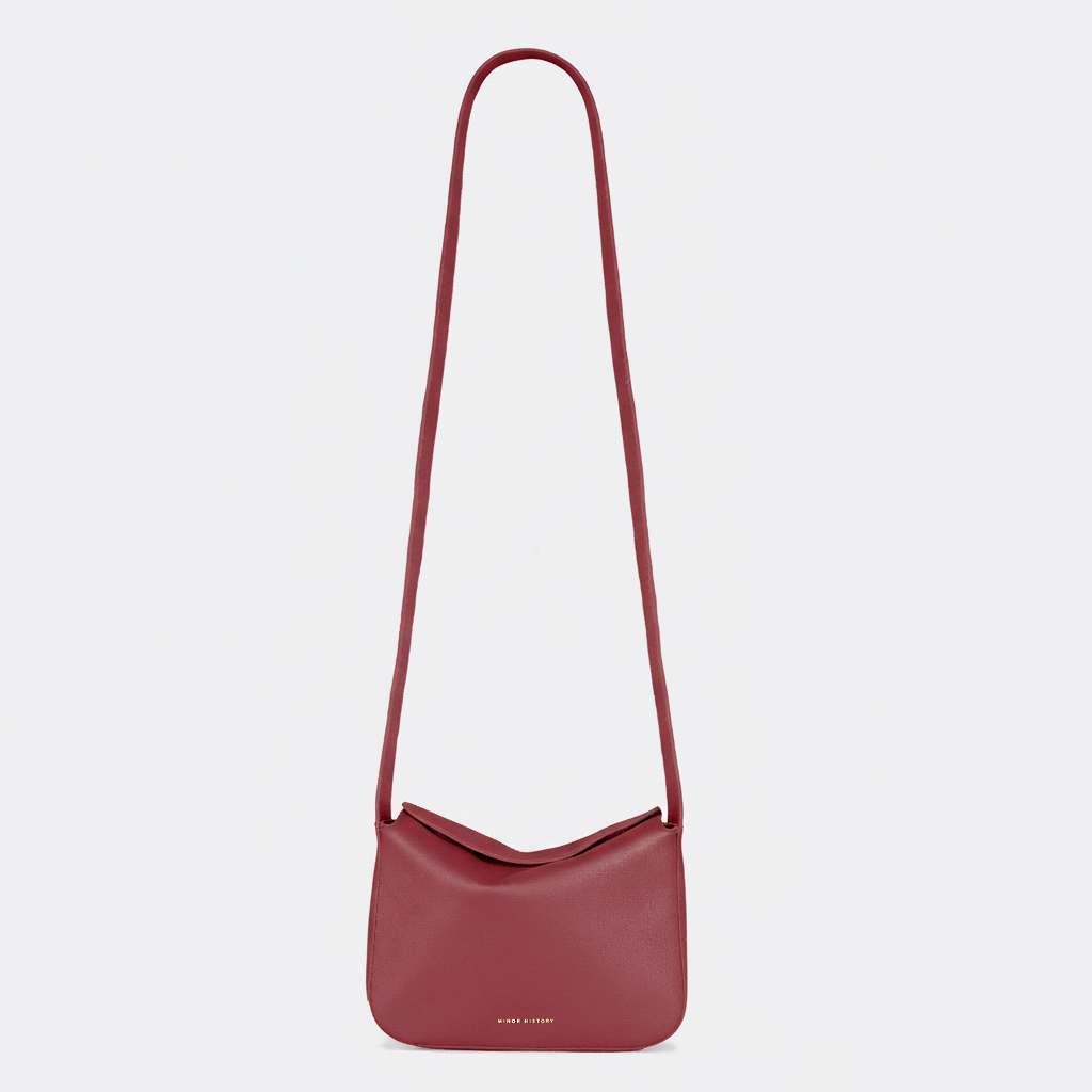 Red shoulder bag on a light gray background - Cherry Cola