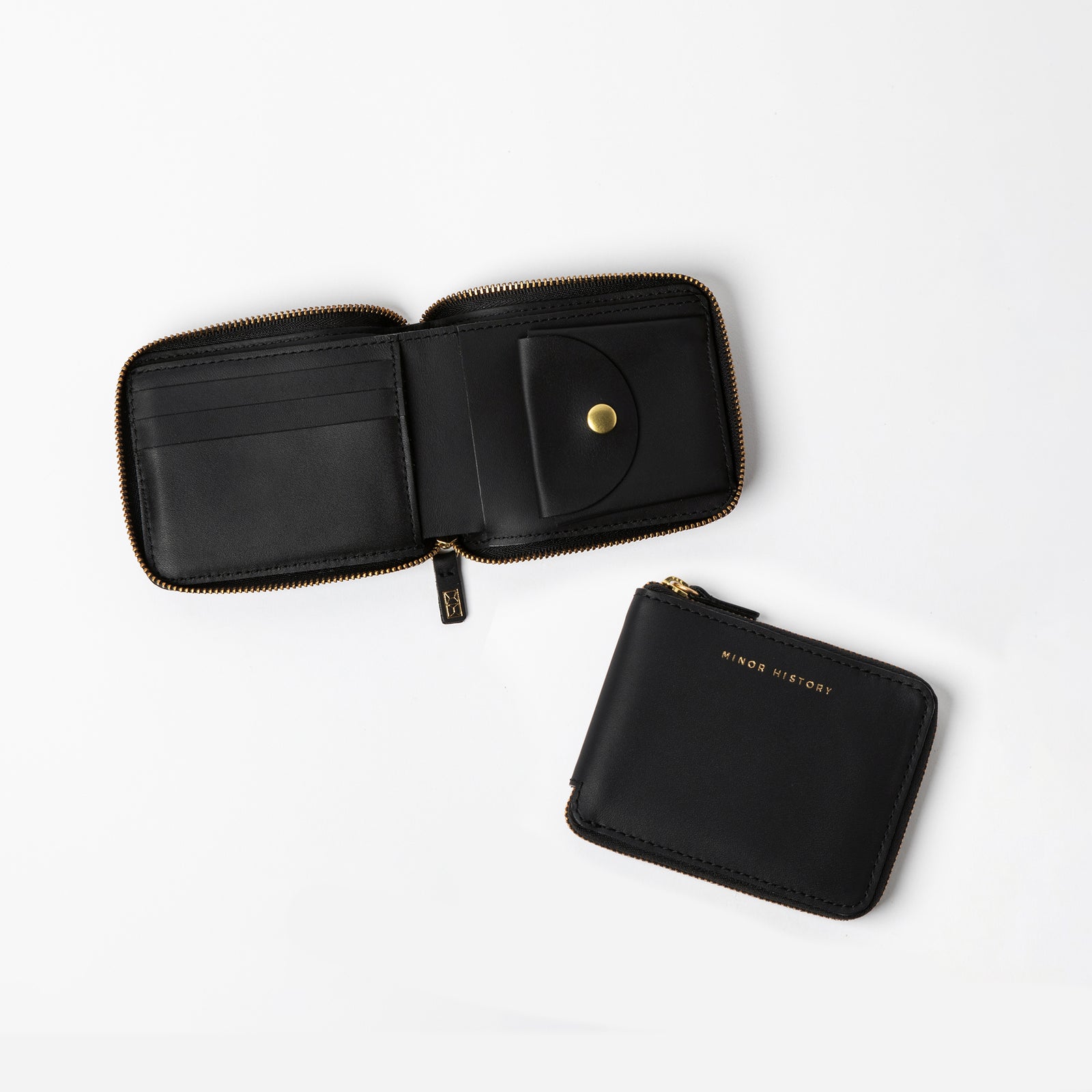 A tan leather wallet open to show the interior with card slots, a billfold, and a coin pouch; the wallet is displayed both open and closed. - Black