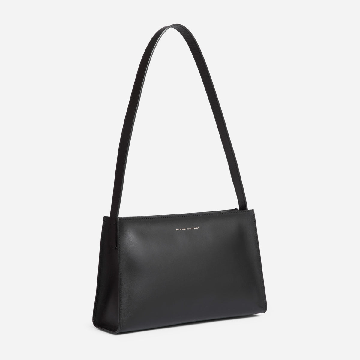Black handbag with a strap on a light gray background - Black