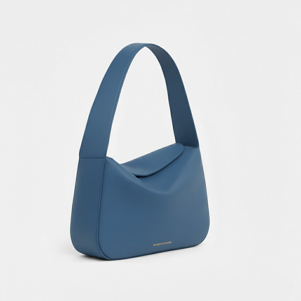 Frame Bag in luxury full-grain leather, styled as a shoulder bag with soft folds - Limelight