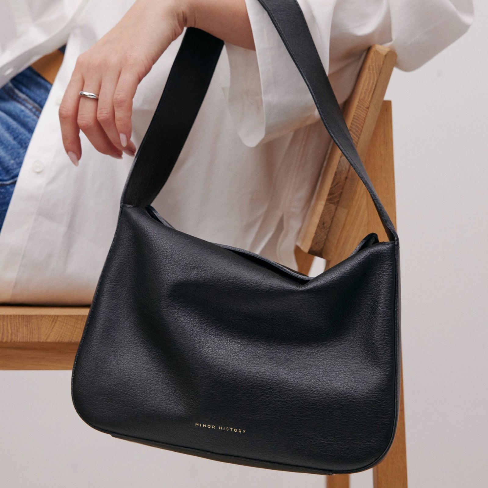 Frame Bag in luxury full-grain leather, detailed studio shot capturing texture and strap design - Black