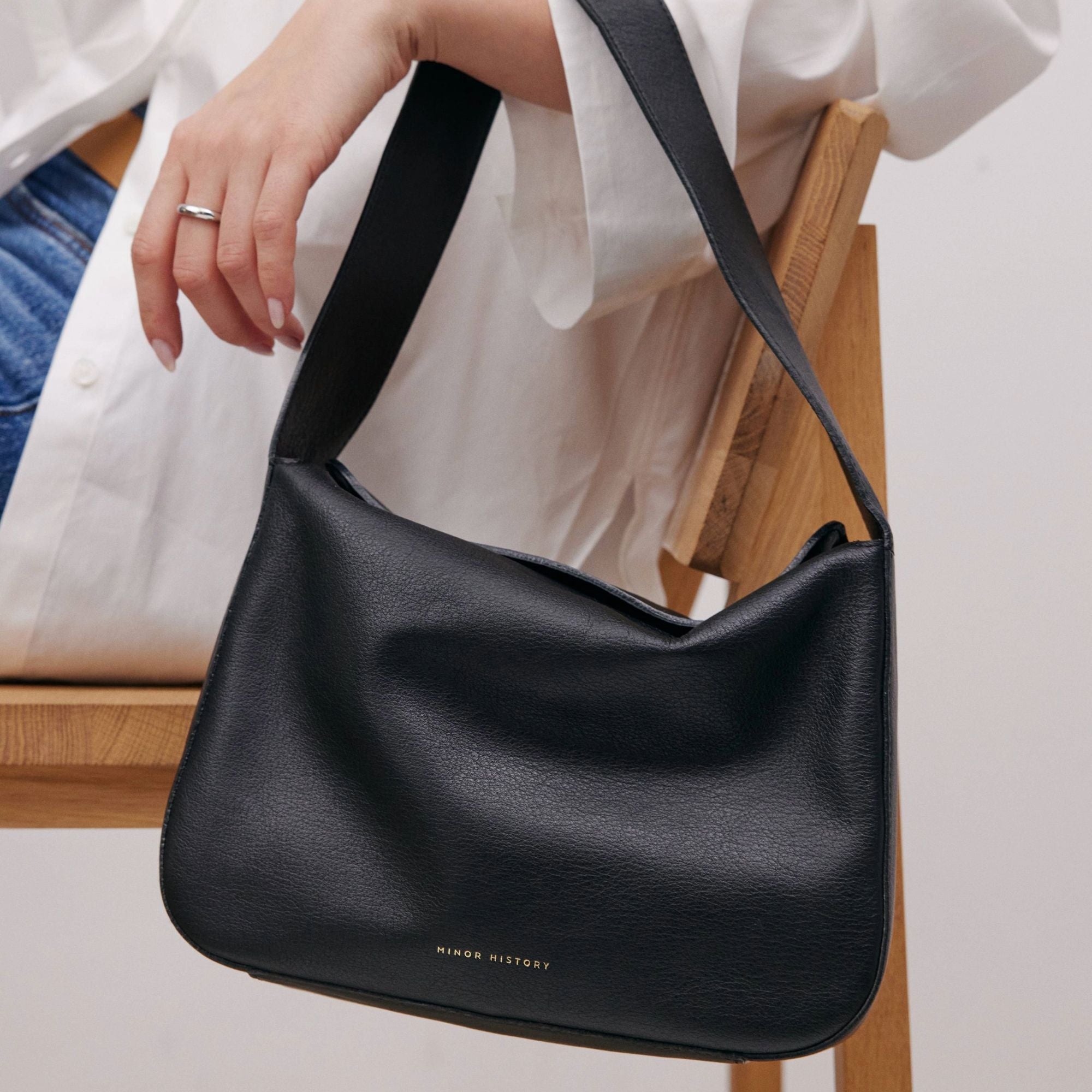 Frame Bag in luxury full-grain leather, styled as a shoulder bag with soft folds - Limelight