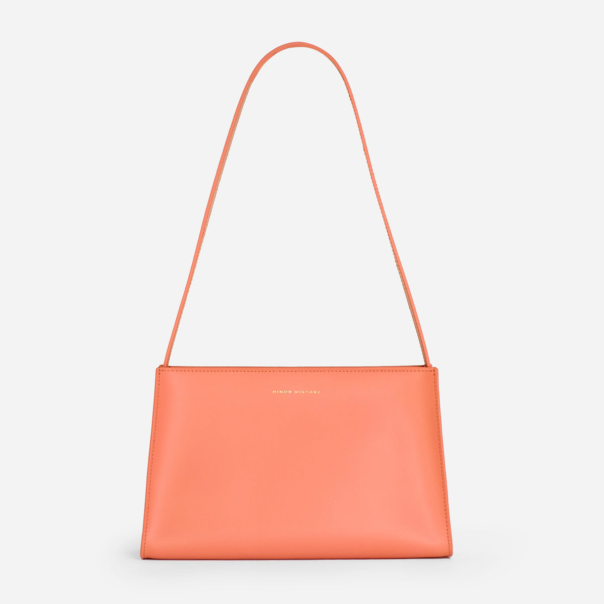 A coral colored leather shoulder bag with a minimal design, a sturdy zipper, and a delicate shoulder strap, displayed against a white background. - Paloma