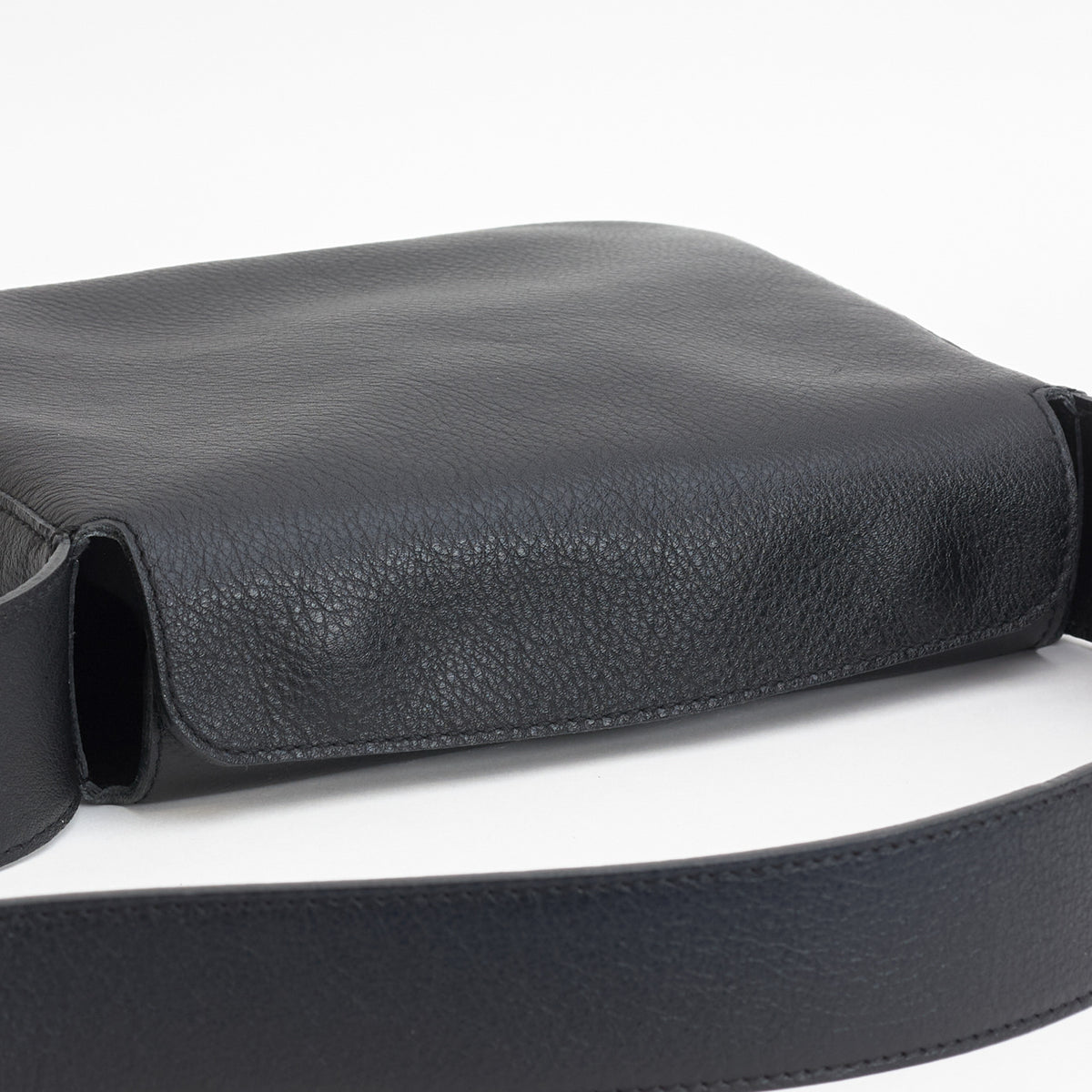 Little Frame crossbody bag in black full-grain leather, angled view highlighting its minimalist design, minimalist women's handbag - Black