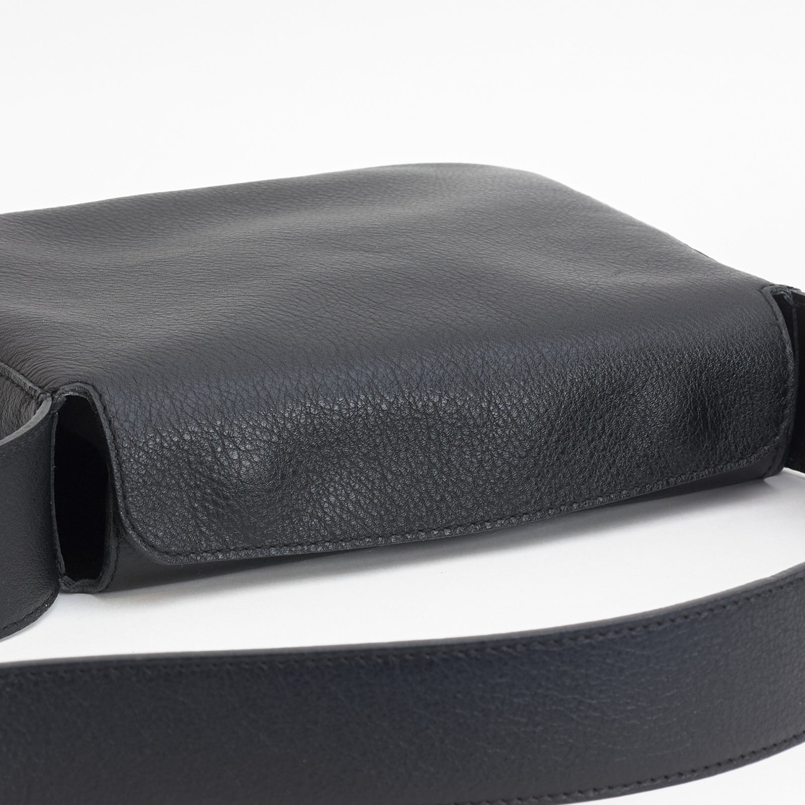Little Frame crossbody bag in black full-grain leather, angled view highlighting its minimalist design, minimalist women's handbag - Black