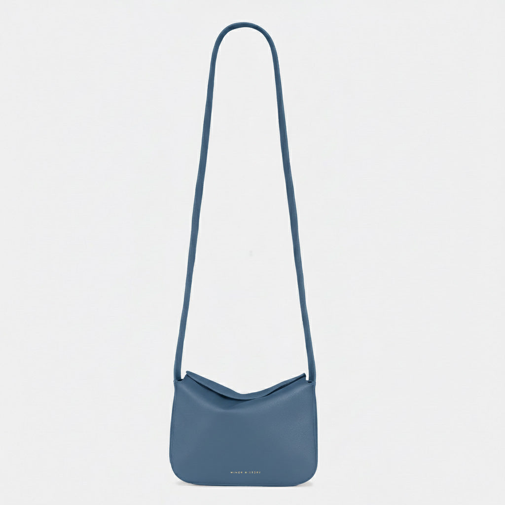 Little Frame crossbody bag in black full-grain leather, front view showcasing its sculpted shape, minimalist women's handbag - Black
