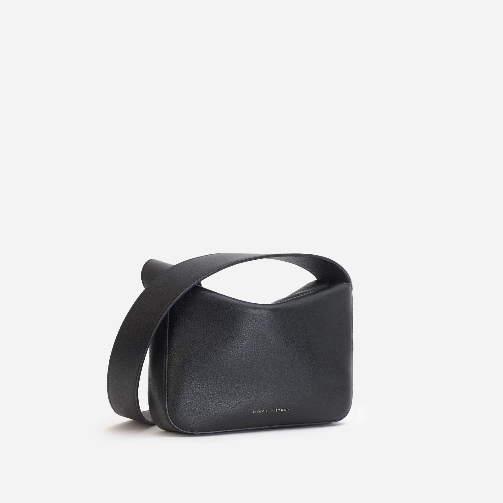 Little Frame crossbody bag in black full-grain leather, front view showcasing its sculpted shape, minimalist women's handbag - Black