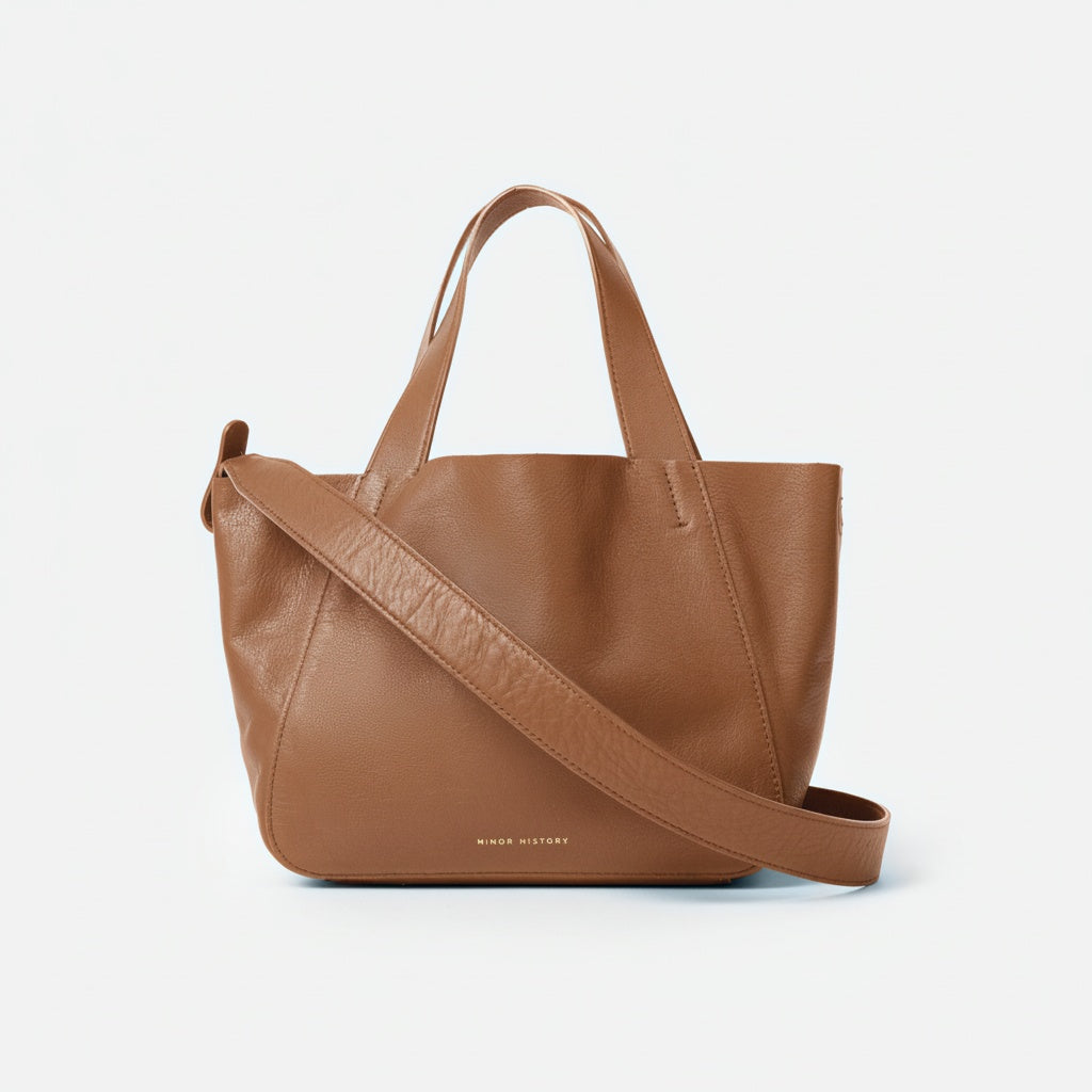 Black handbag with a shoulder strap on a white background - Black