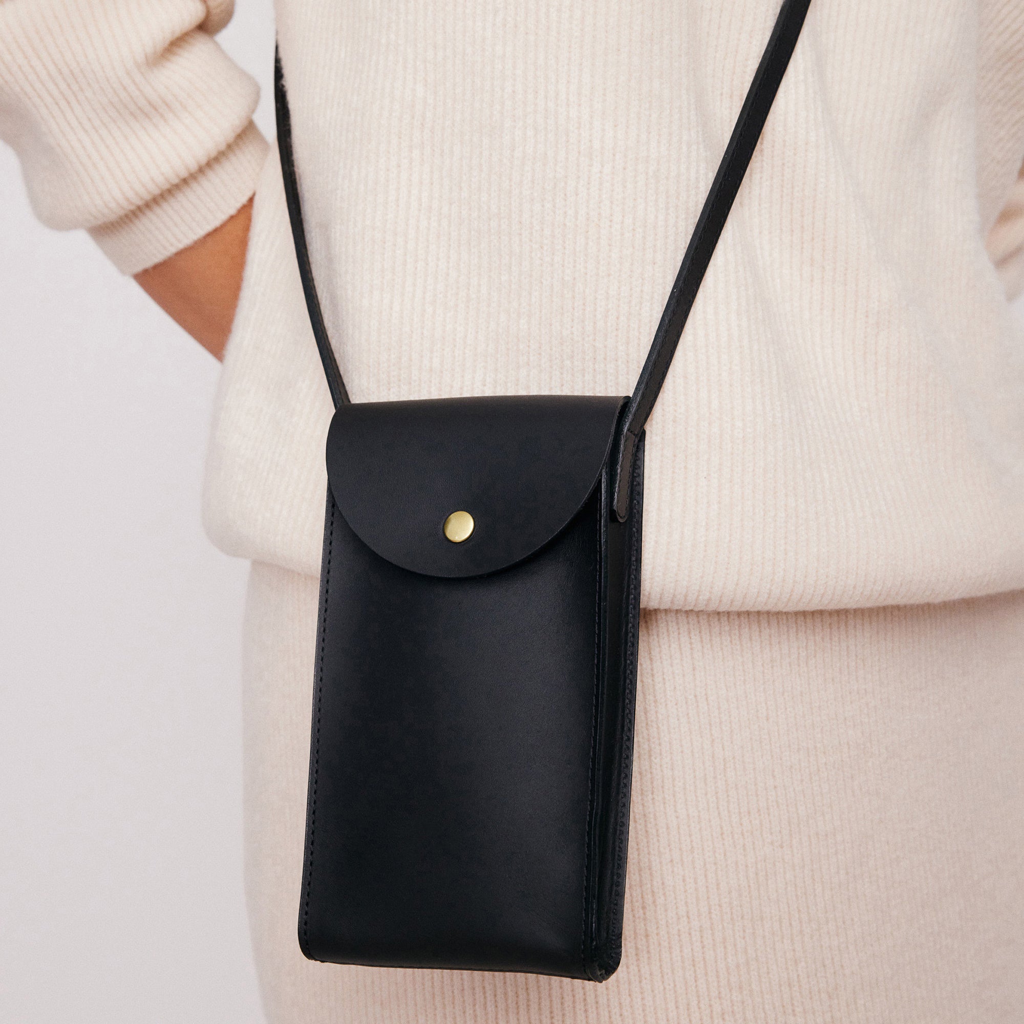 Mini Bandit crossbody bag in black full-grain leather, cropped view highlighting texture and stitching - Black