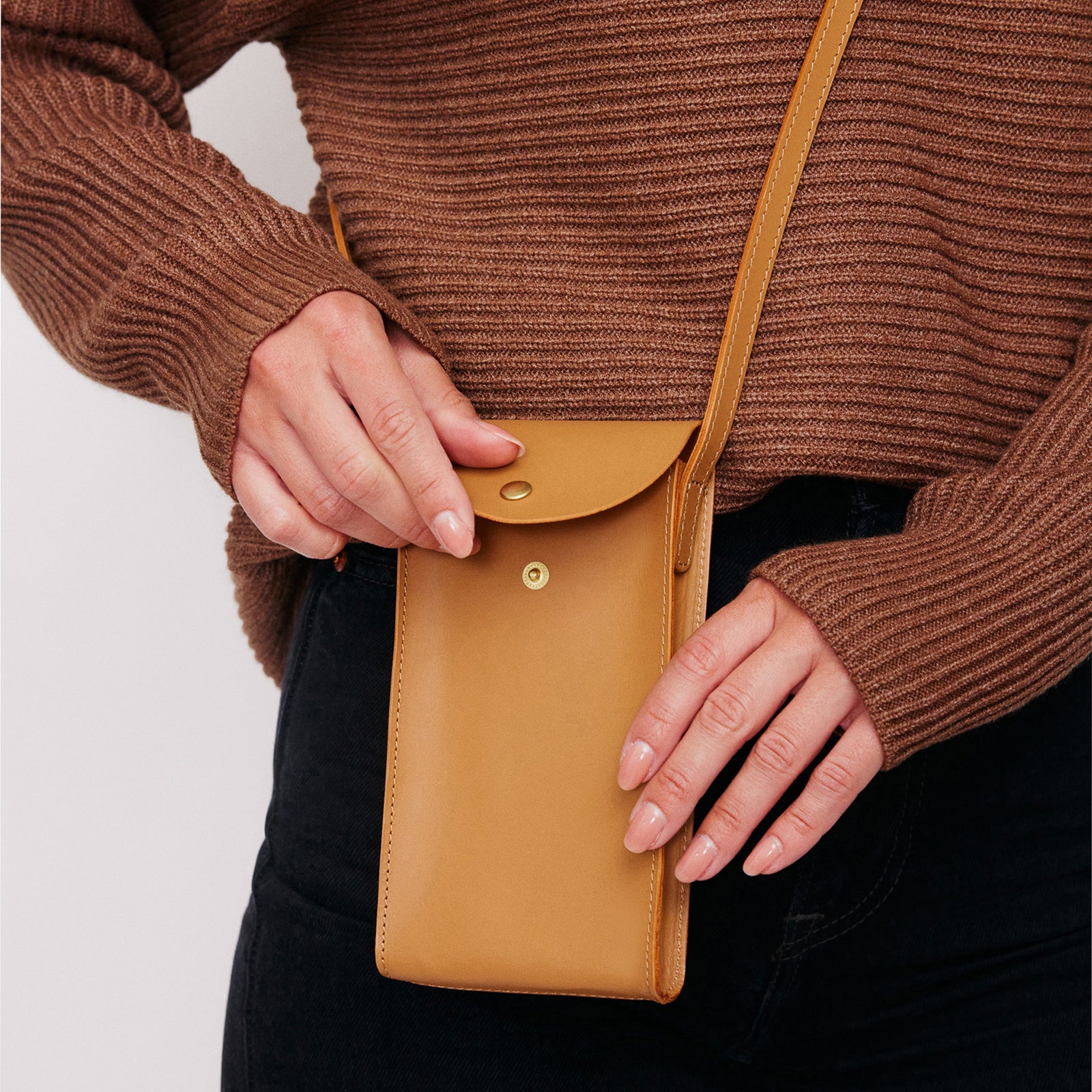 Mini Bandit crossbody bag in saddle brown full-grain leather, cropped view highlighting texture and stitching - Saddle - Saddle