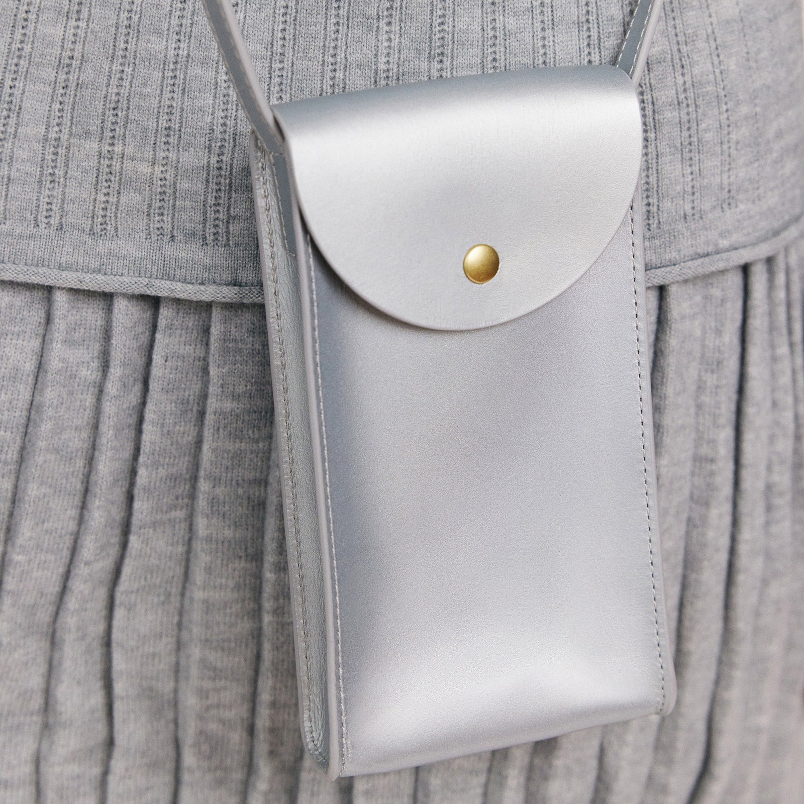 Mini Bandit crossbody bag in sterling silver full-grain leather, cropped view highlighting texture and stitching  - Sterling