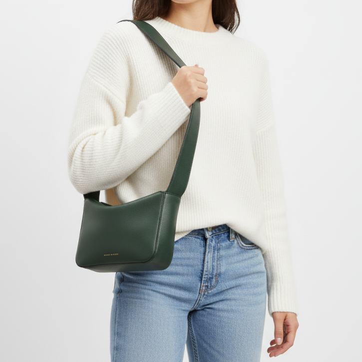 Little Frame crossbody bag in black full-grain leather, front view showcasing its sculpted shape, minimalist women's handbag - Black