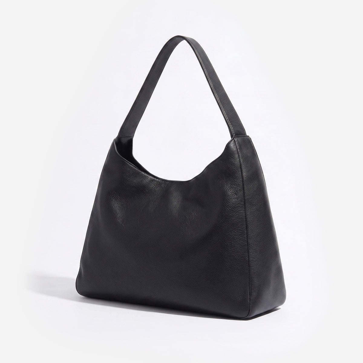 A black pebbled leather hobo shoulder bag with a single strap, photographed on a clean white background. -Black