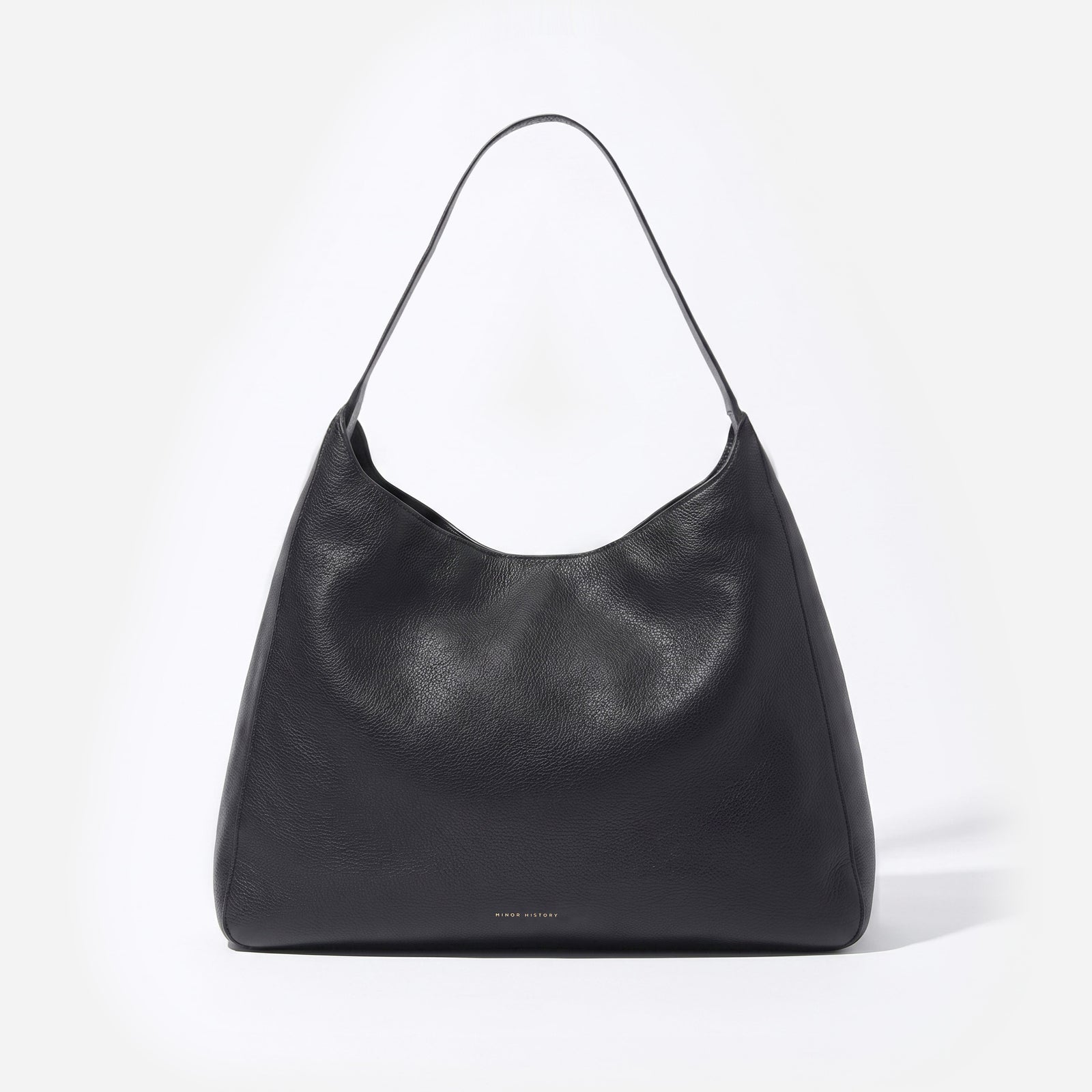 A black leather slouchy shoulder bag with a single strap, photographed against a clean white background. -Black