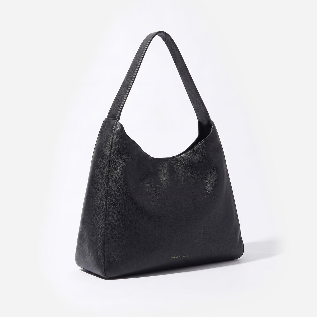 Black leather handbag on a light gray background - Black
