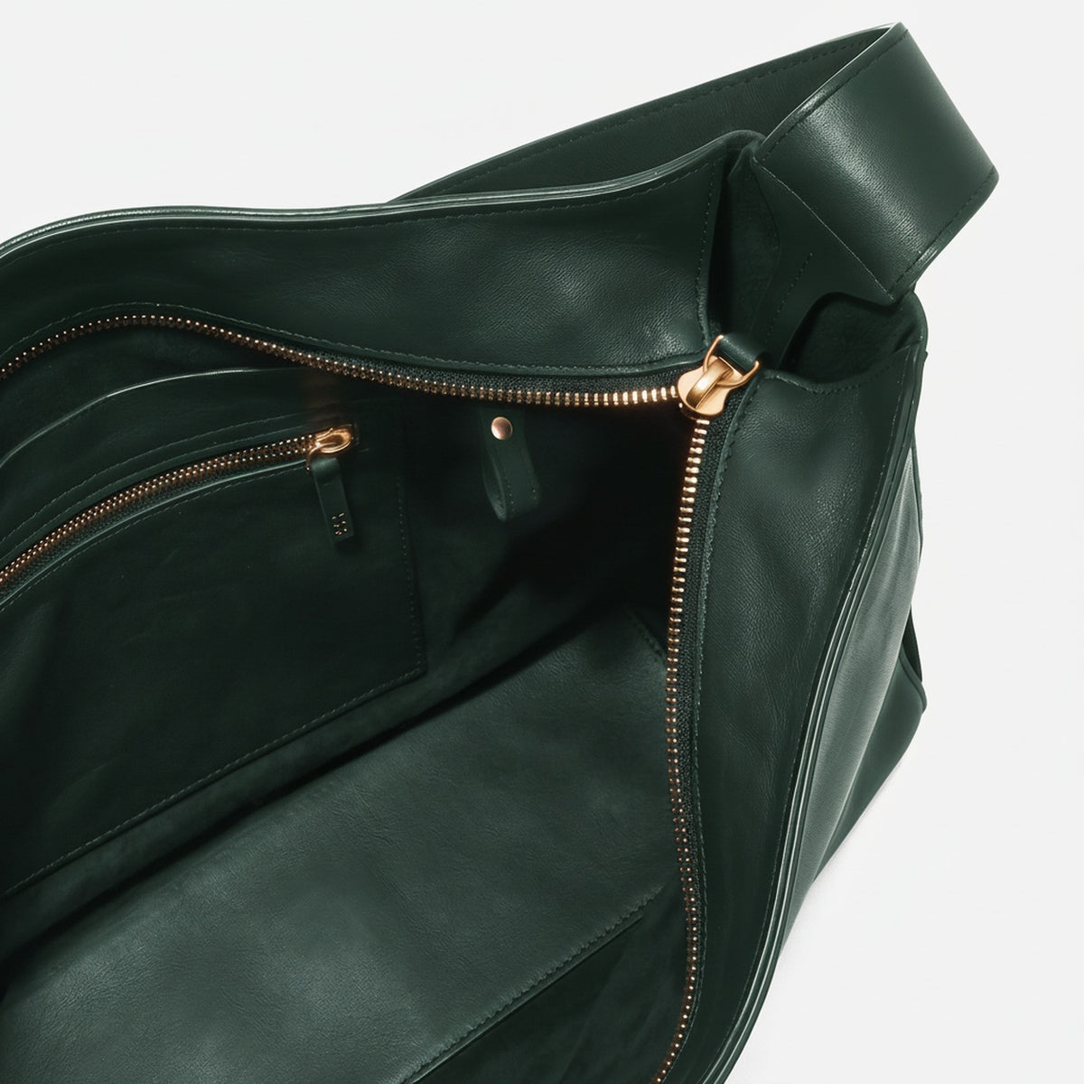 Green leather bag with gold zipper on a white background  -Evergreen