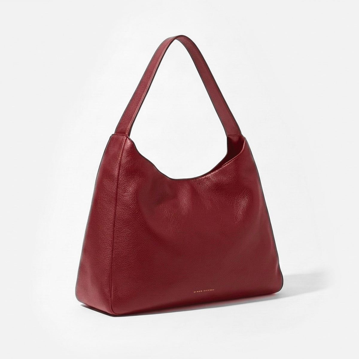 A burgundy pebbled leather hobo shoulder bag with a single strap, shown from a three-quarter angle on a clean white background. -Cherry Cola