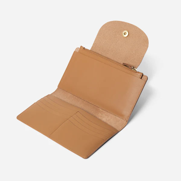 A black leather travel wallet with a snap closure and a gold-tone button. -Black