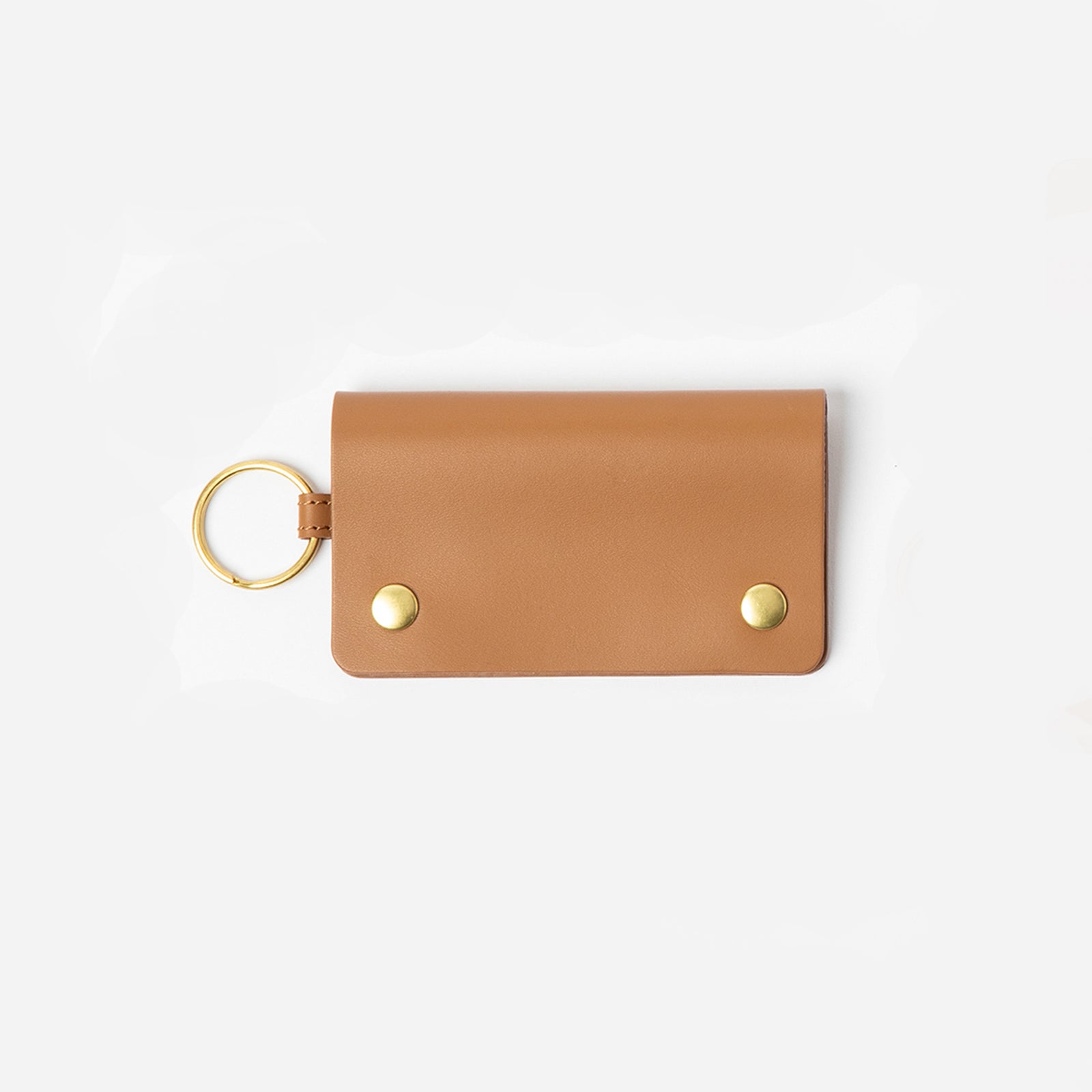 Black keychain cardholder with gold accents on a white background - Black