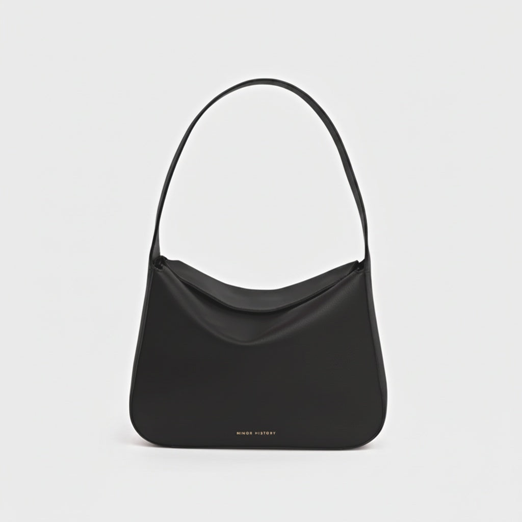 Frame Bag in luxury full-grain leather, styled as a shoulder bag with soft folds - Limelight
