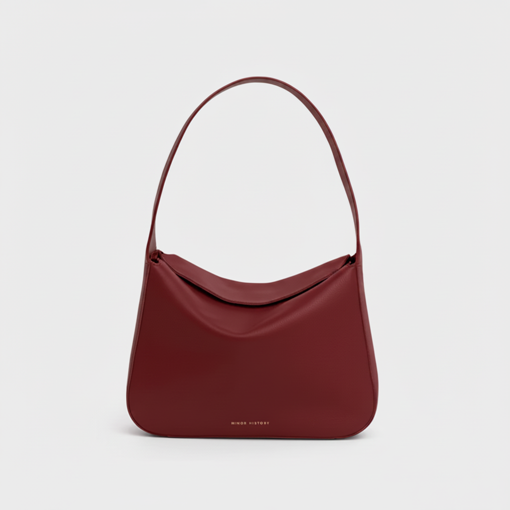 Frame Bag in luxury full-grain leather, styled as a shoulder bag with soft folds - Limelight