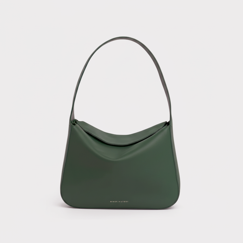 Green handbag on a light gray background - Evergreen