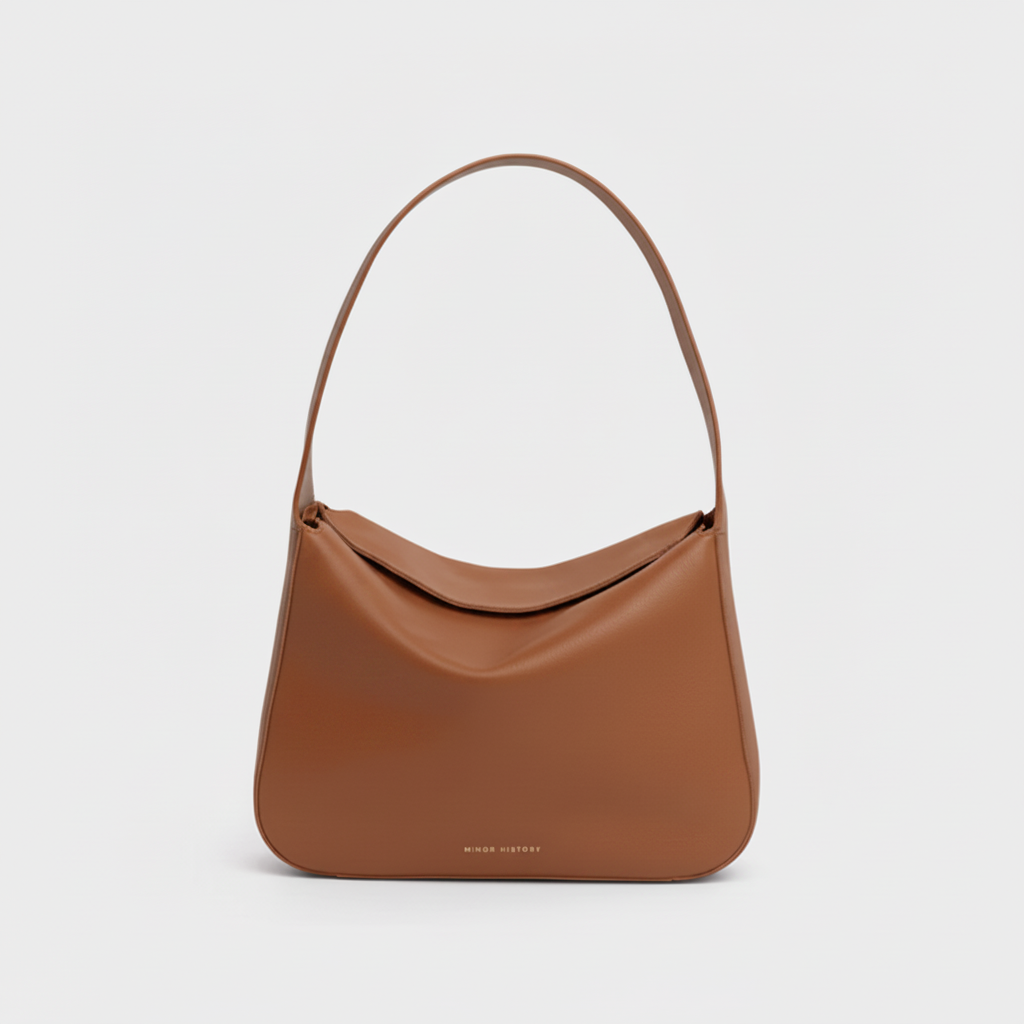 Frame Bag in luxury full-grain leather, styled as a shoulder bag with soft folds - Limelight