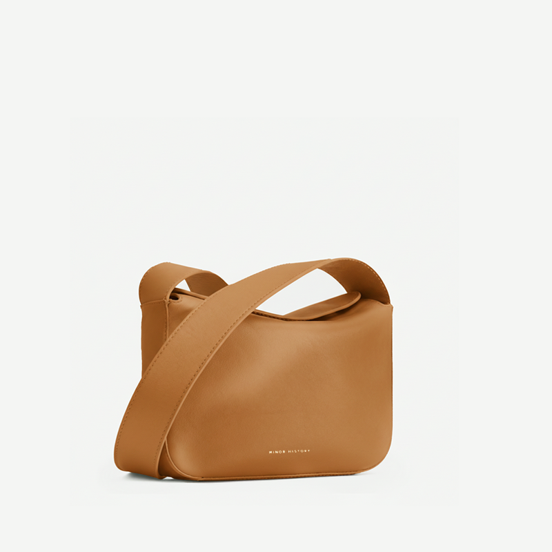 Little Frame crossbody bag in black full-grain leather, front view showcasing its sculpted shape, minimalist women's handbag - Black