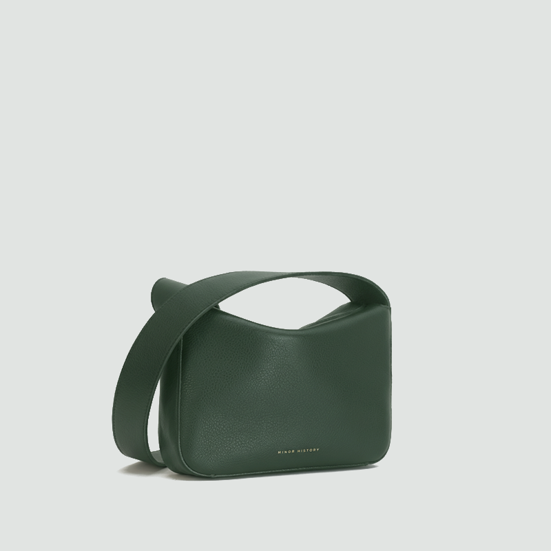 Green handbag on a light gray background  - Evergreen