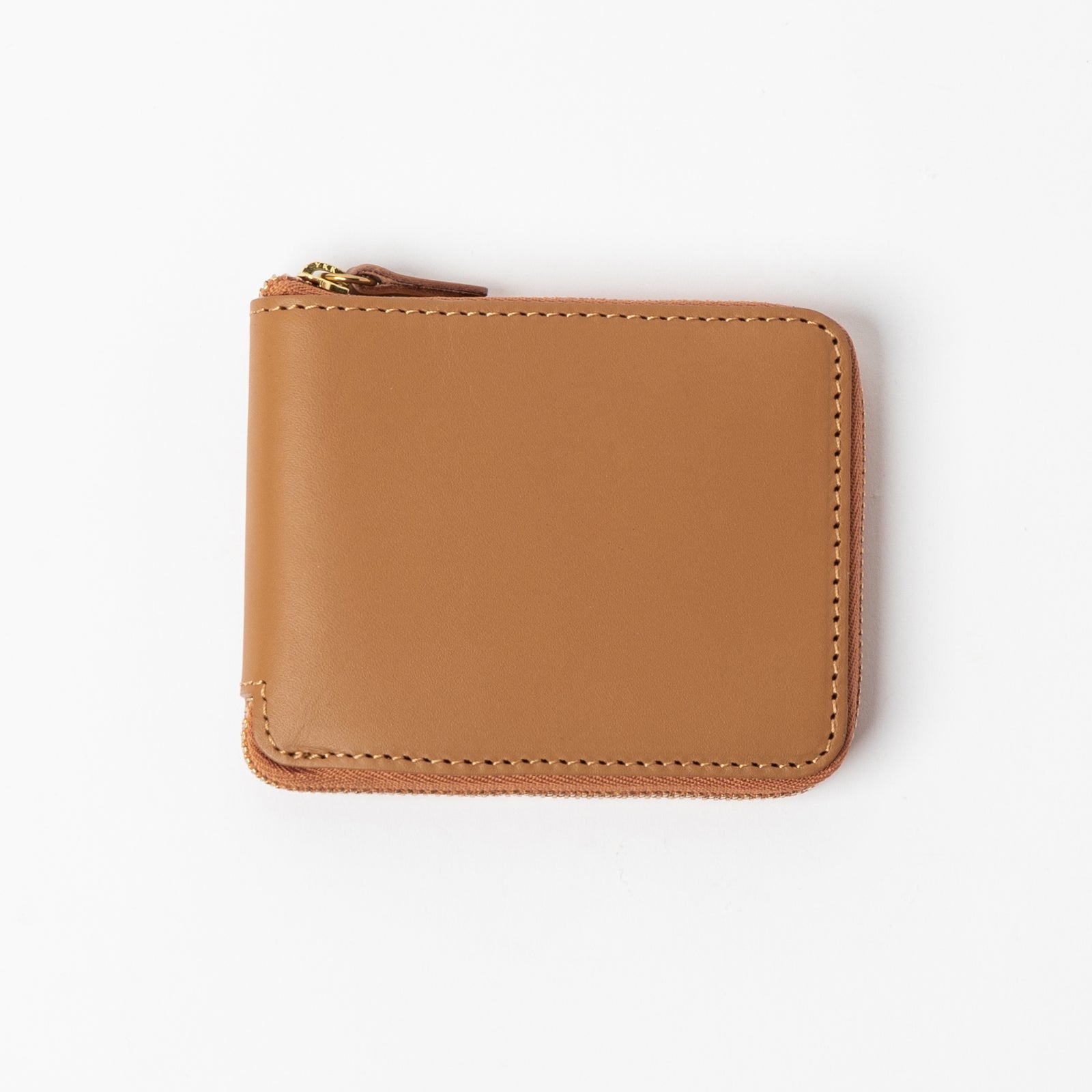 Brown wallet with 'Minor History' branding on a pink fabric background - Saddle