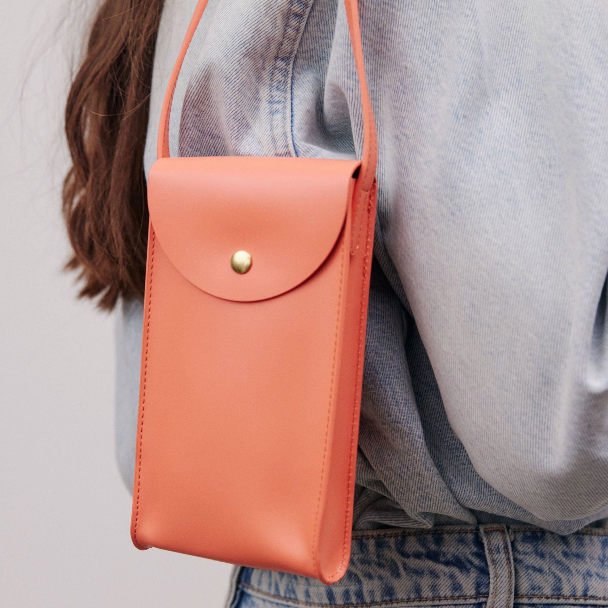 Mini Bandit crossbody bag in black full-grain leather, cropped view highlighting texture and stitching - Black