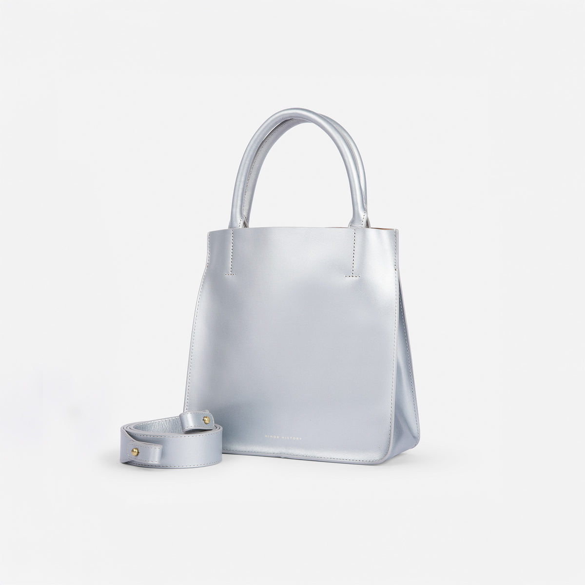 Silver handbag with matching strap on a white background - Sterling