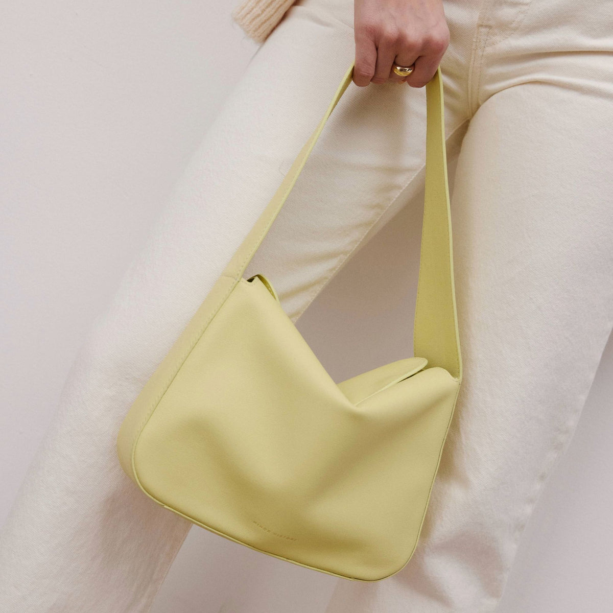 Frame Bag in luxury full-grain leather, minimalist women's handbag in a bright studio setting - Limelight